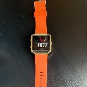 Fitbit Smartwatch with Orange Band and Gold Case